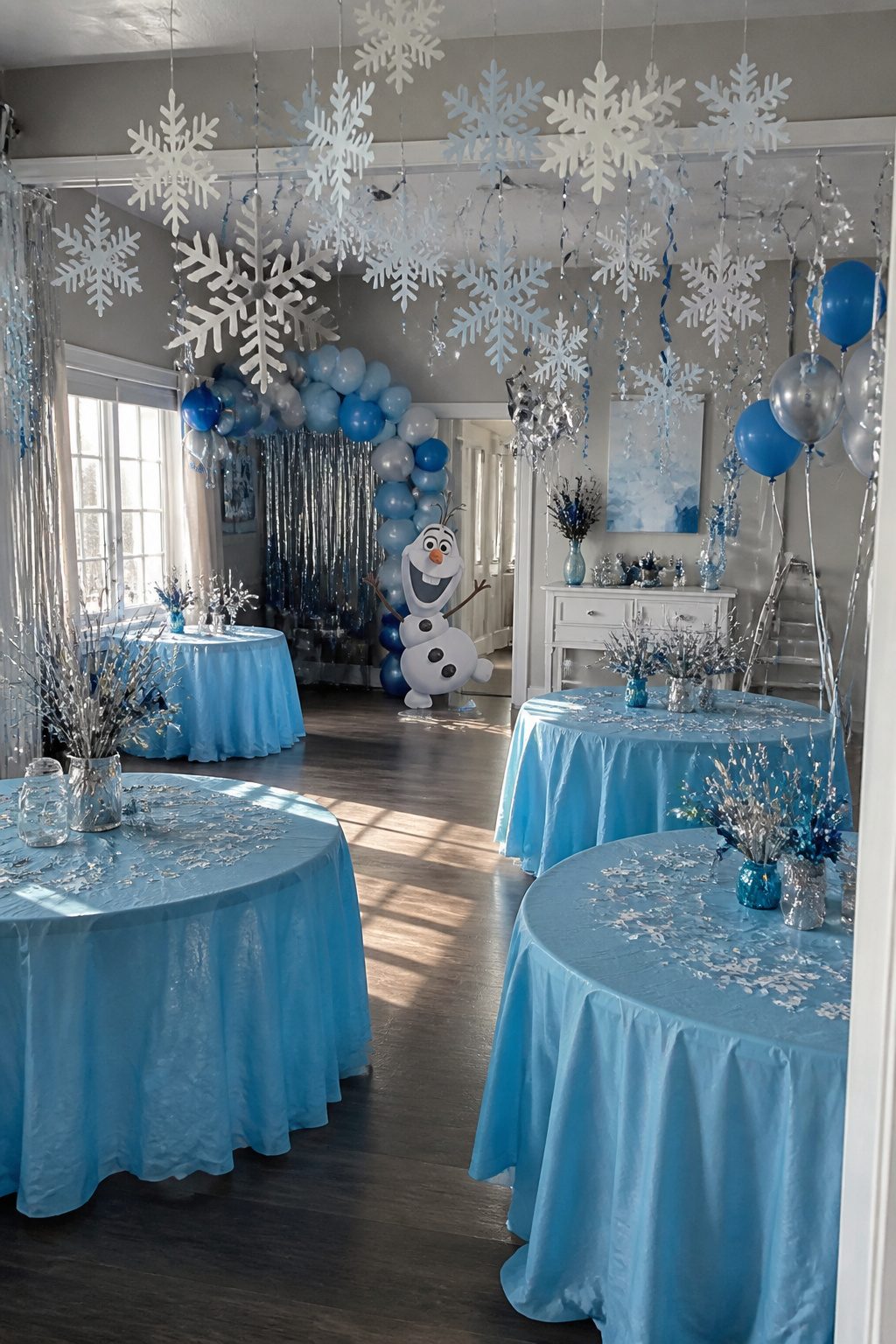 Frozen Themed Birthday Party: Your Complete 2026 Guide 2 Tablecloths and snowflake decorations in icy blue and silver.