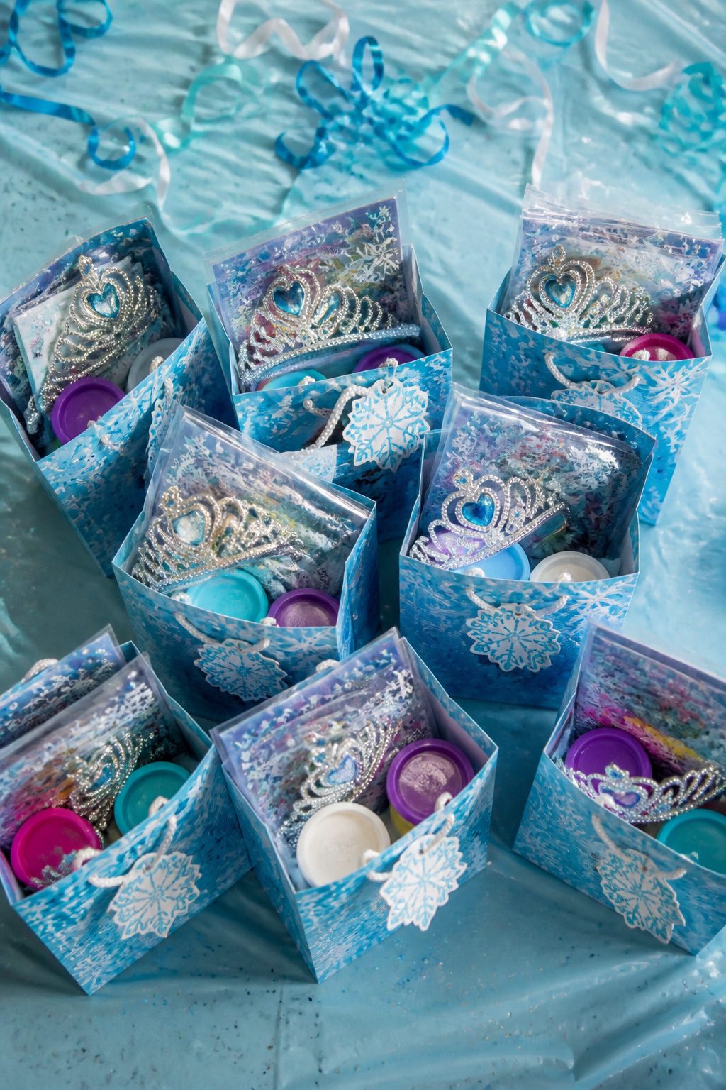 Frozen Themed Birthday Party: Your Complete 2026 Guide 5 Frozen-themed party favor bags with stickers and play dough.