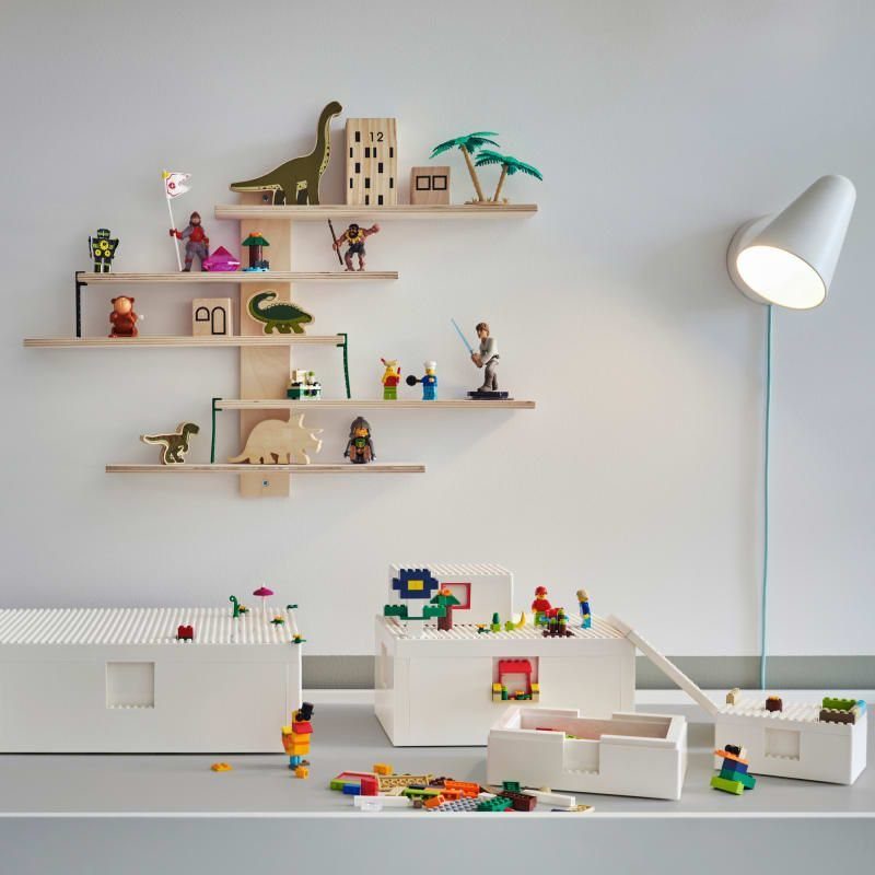 White BYGGLEK LEGO storage boxes filled with colorful bricks and minifigures on a white surface.