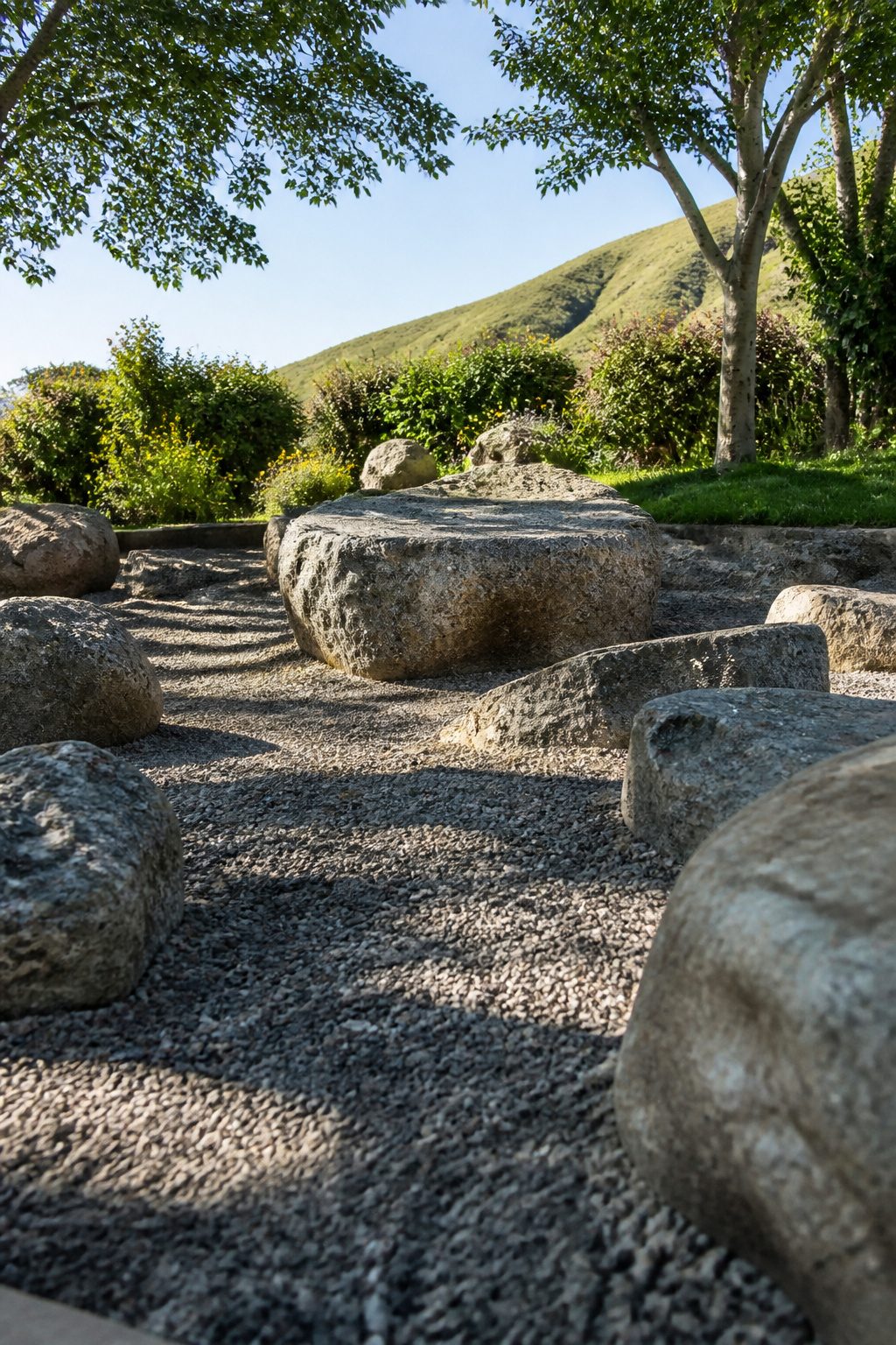 Kids climbing on various sized rocks and boulders in a playground.