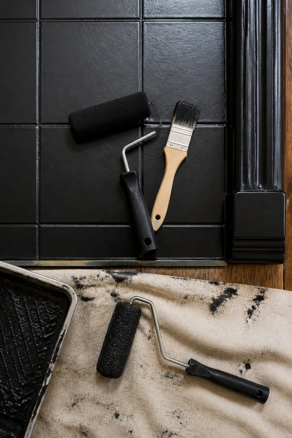 Foam roller and brush used for painting fireplace tiles.
