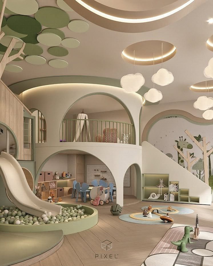 A multi-level indoor playroom with a slide, ball pit, loft, and tree-themed decor.