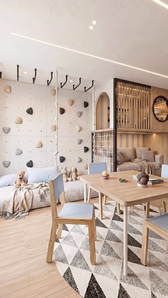 9 Small Play Area Ideas for Families Short on Space 4 A modern playroom with a climbing wall, wooden table, and comfortable lounge seating area.