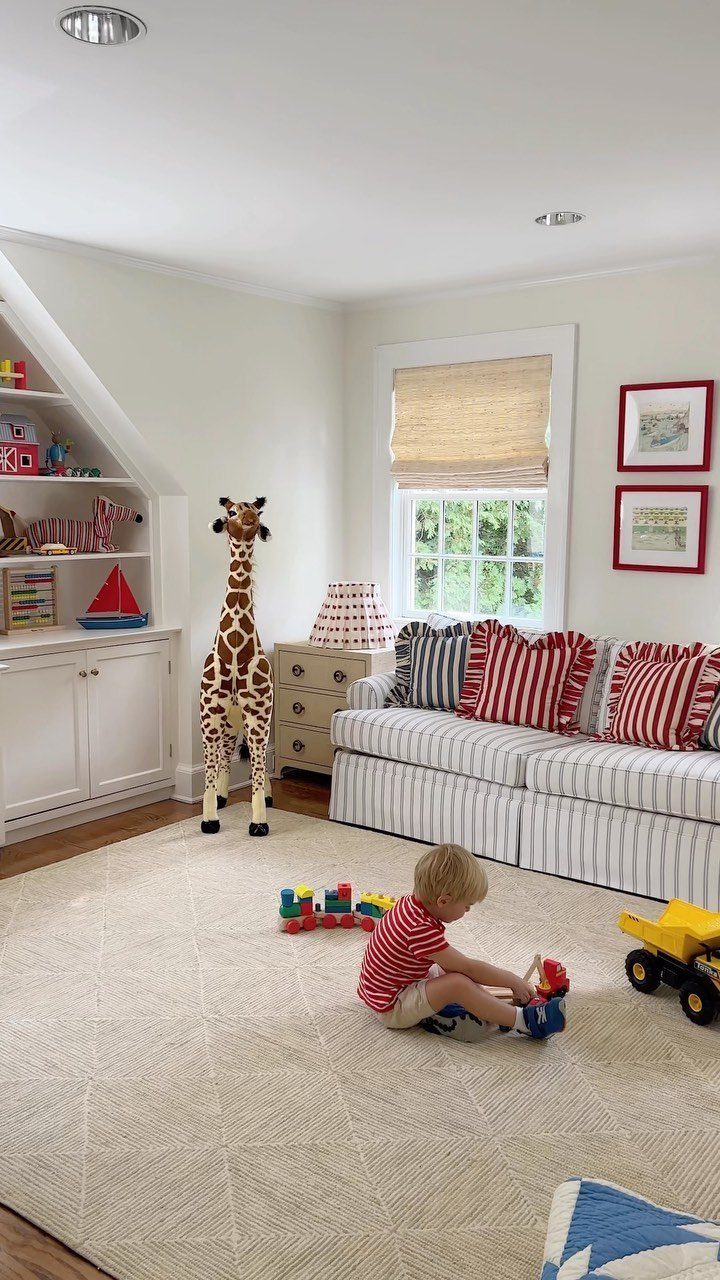 9 Small Play Area Ideas for Families Short on Space 6 A toddler playing with colorful toy blocks on a large cream textured area rug.