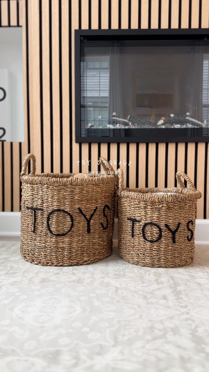 9 Small Play Area Ideas for Families Short on Space 3 Two woven seagrass baskets with the word TOYS printed on them sit on a rug.