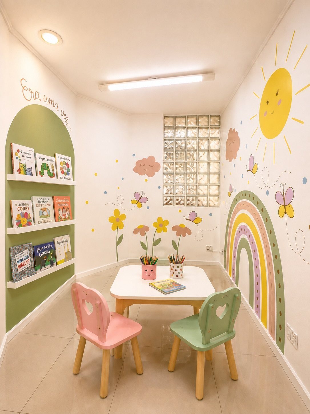23 Small Playroom Design Ideas That Fit Real Rooms 10 Children's playroom with colorful sun, rainbow, and flower wall murals and a small table.