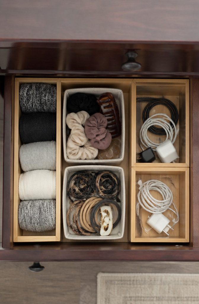 Small Room Organization Bedroom Guide for Tight Spaces 3 A junk drawer with dividers separating various items.